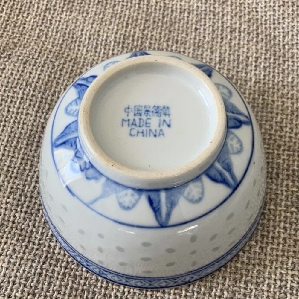 Small Chinese blue white porcelain bowl with brown glaze specks.
